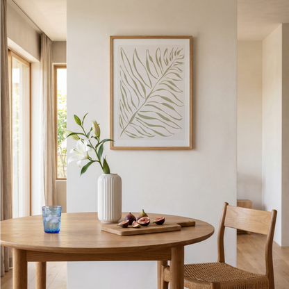 Akvarellposter med palmblad i olivgrönt, upphängd i matplats vid runt bord