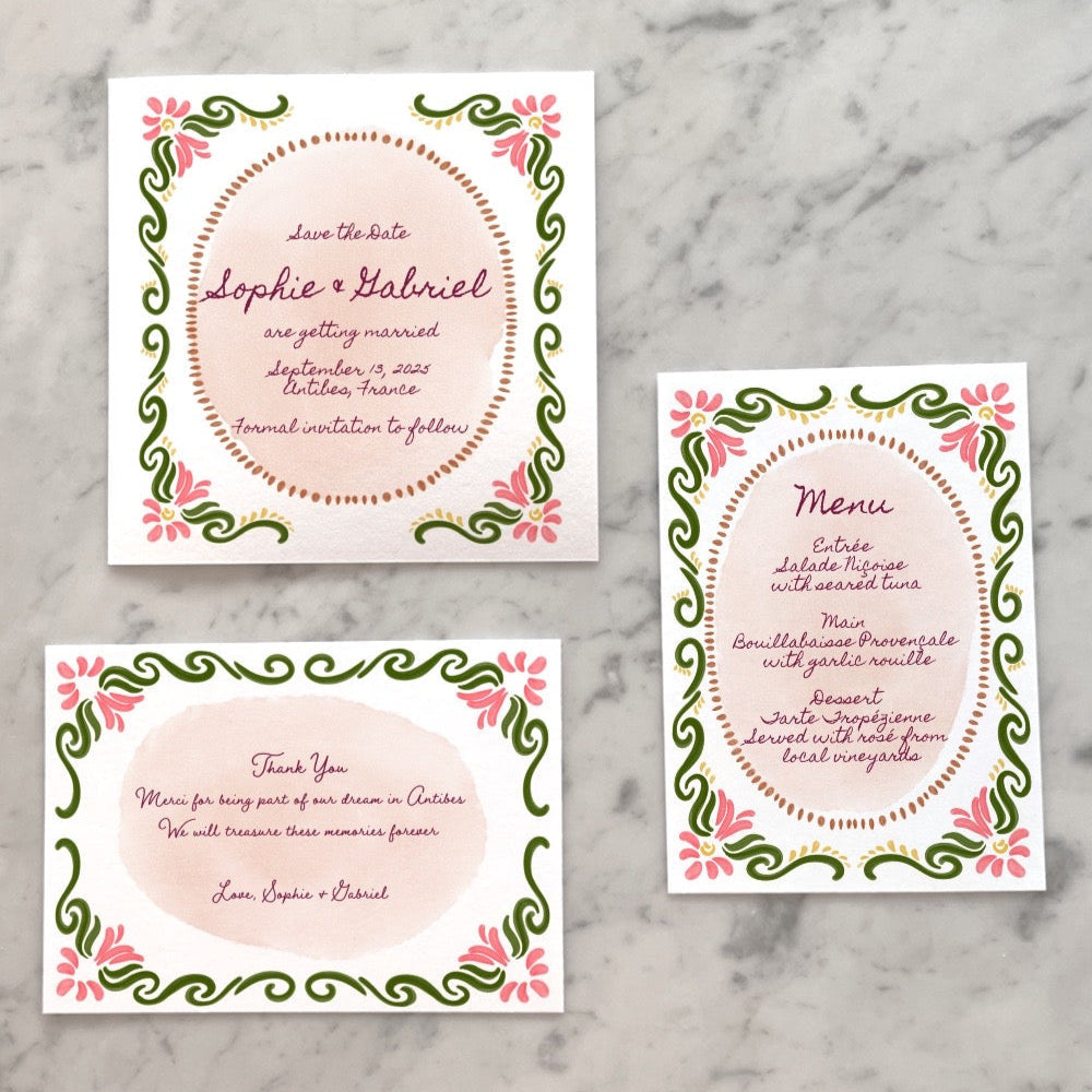 Close-up of the Kurbits wedding invitation with green vines and pink flowers