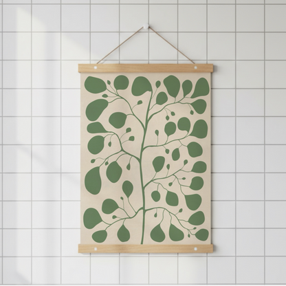 Pilea-illustration upphängd med en magnetisk posterlist i trä på en vit kakelvägg. Enkel och ren design för den moderna minimalistiska inredningsstilen.